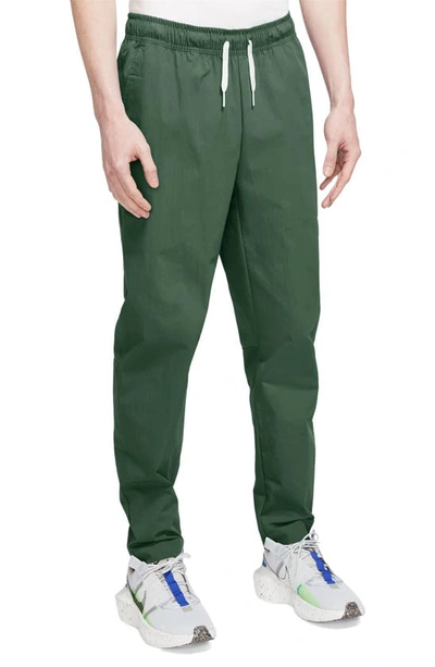 Shop Nike Woven Tapered Leg Pants In Fir/ White