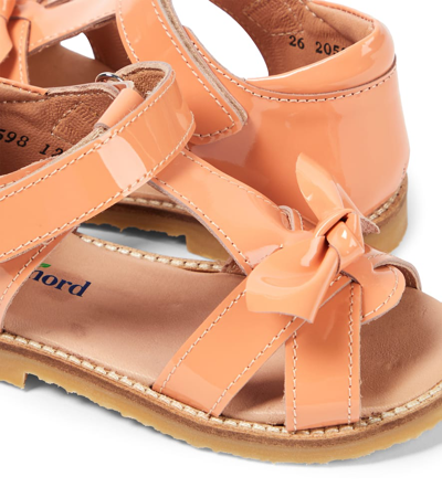 Shop Petit Nord Bow Patent Leather Sandals In Orange