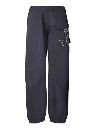 Shop Jw Anderson Embroidered Logo Trousers In Blue