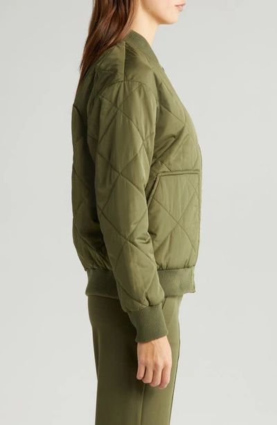 Shop Zella Quilted Side Zip Bomber Jacket In Olive Night