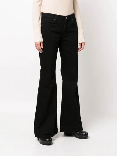 Shop Re/done 70s Mid-rise Flared Jeans In Black