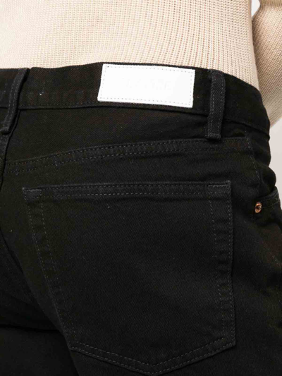 Shop Re/done 70s Mid-rise Flared Jeans In Black