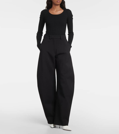 Shop Alaïa High-rise Wool Barrel-leg Pants In Black