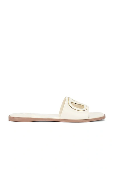 Shop Valentino V Logo Cut Out Slide In Light Ivory & Antique Brass