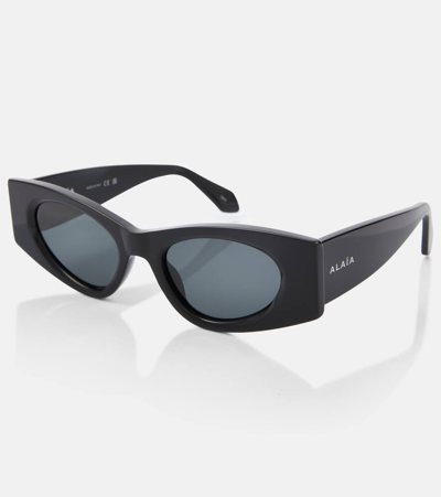 Shop Alaïa Logo Oval Sunglasses In Black