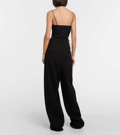 Shop Khaite Simone Pleated Wide-leg Pants In Black