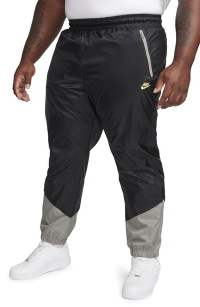 Shop Nike Windrunner Woven Lined Pants In Black/ Dark Stucco/ Saturn
