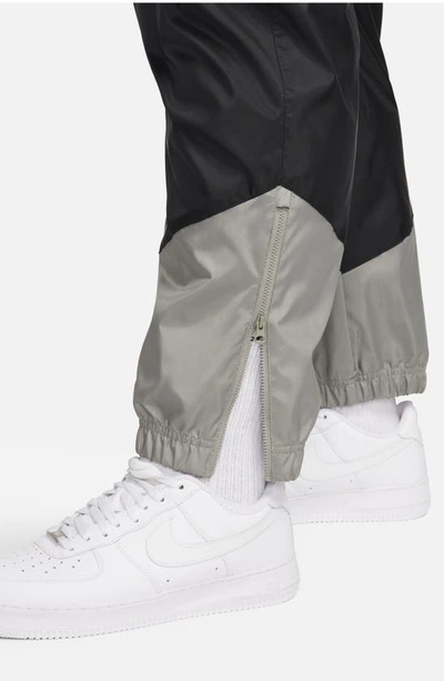 Shop Nike Windrunner Woven Lined Pants In Black/ Dark Stucco/ Saturn