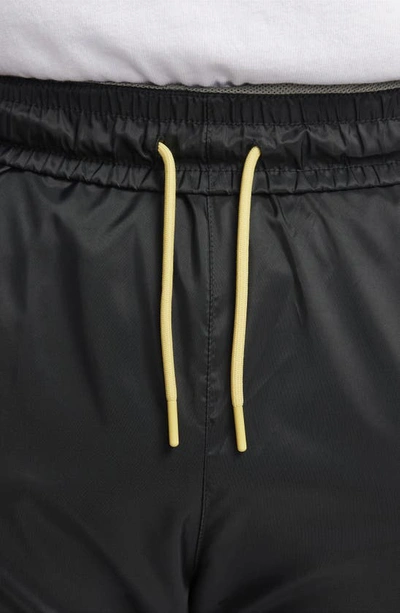 Shop Nike Windrunner Woven Lined Pants In Black/ Dark Stucco/ Saturn