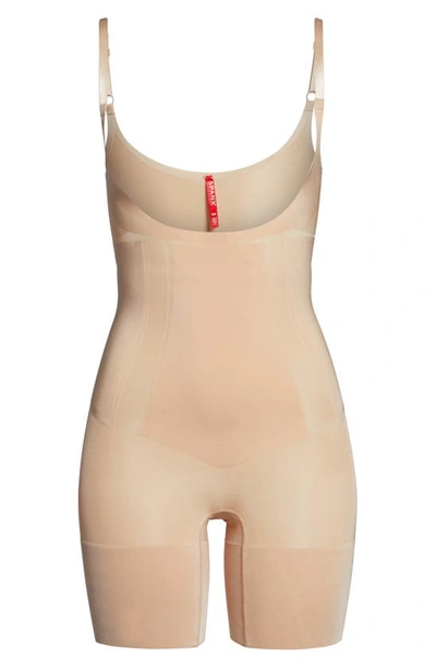 Shop Spanx Oncore Open Bust Mid Thigh Shaper Bodysuit In Soft Beige