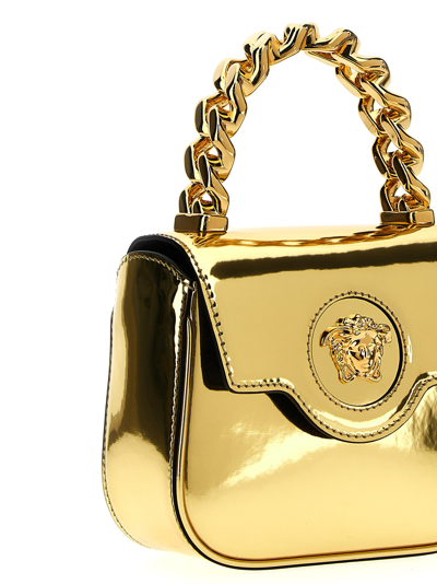 Shop Versace La Medusa Mini Handbag In Gold