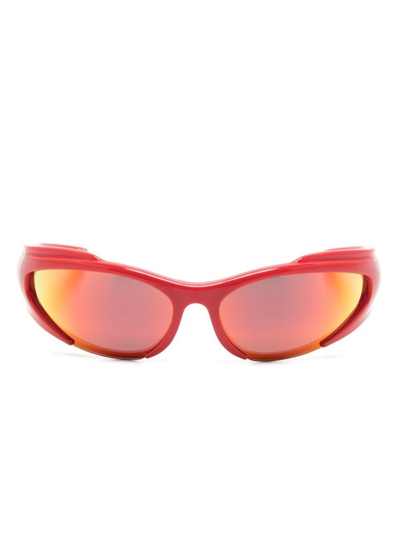Shop Balenciaga Wrap Around Frame Sunglasses In Red