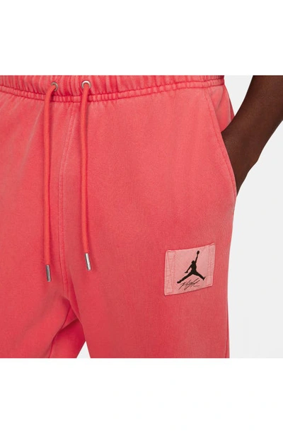 Shop Jordan Flight Essentials Washed Cotton Fleece Sweatpants In Lobster