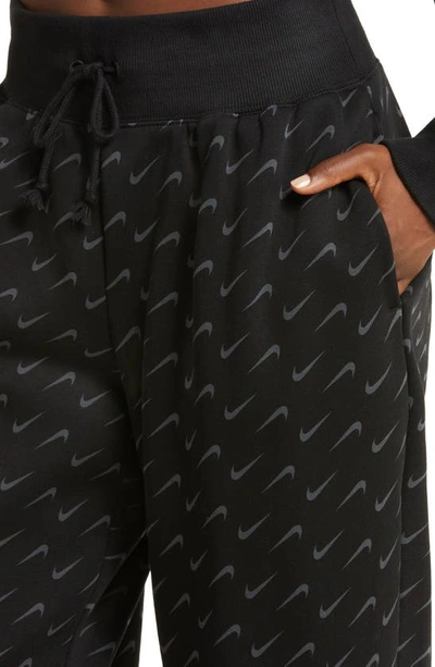 Shop Nike Swoosh Print Cotton Blend Fleece Sweatpants In Black