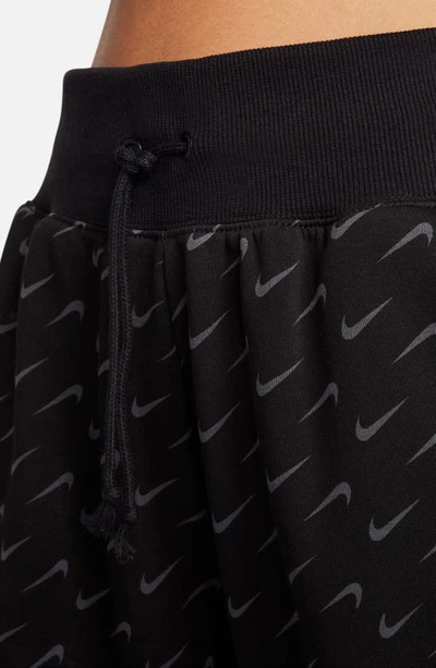 Shop Nike Swoosh Print Cotton Blend Fleece Sweatpants In Black