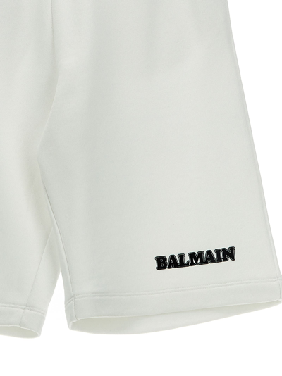 Shop Balmain Logo Print Bermuda Shorts In White/black