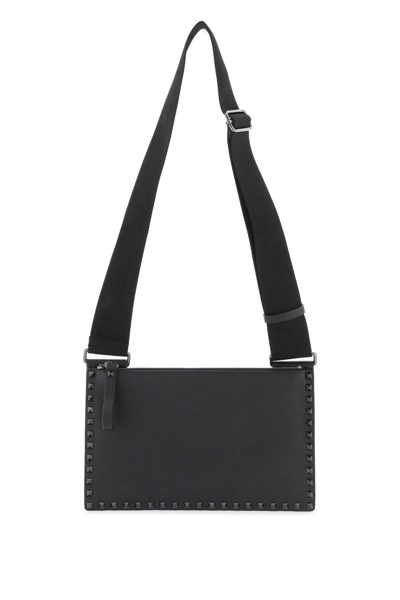 Shop Valentino Rockstud Flat Crossbody Bag In Black