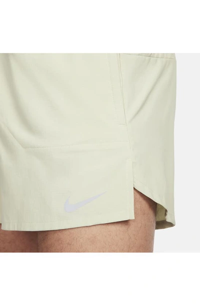 Shop Nike Dri-fit Stride 5-inch Running Shorts In Olive Aura/ Dark Stucco