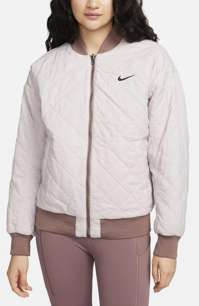 Shop Nike Sportswear Reversible Varsity Quilted Bomber Jacket In Smokey Mauve/ Violet/ Black