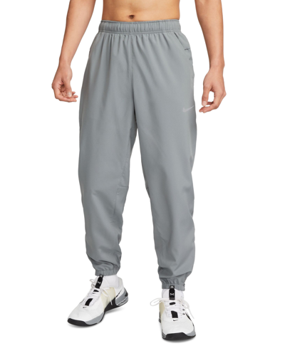 Shop Nike Men's Form Dri-fit Standard-fit Tapered-leg Training Pants In Smoke Grey,black,(reflective Silv)