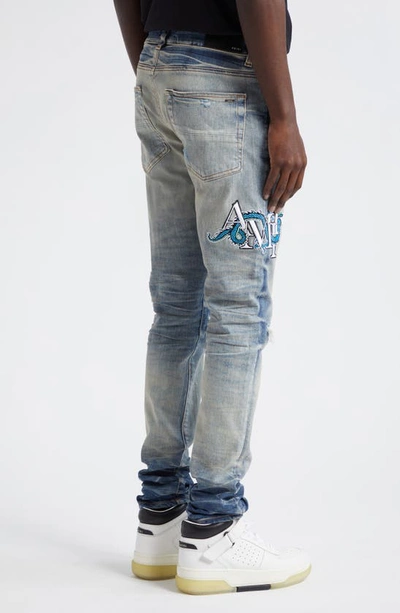 Shop Amiri Mx1 Dragon Lunar New Year Ripped & Patched Jeans In Vintage Indigo