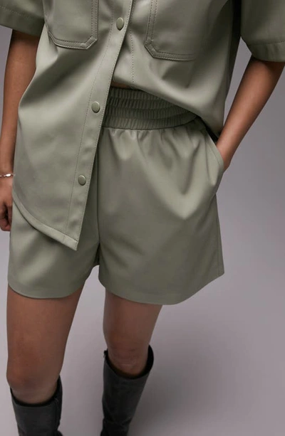 Shop Topshop Pull-on Faux Leather Shorts In Light Green