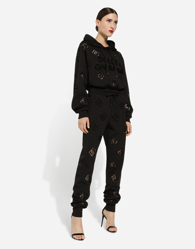 Shop Dolce & Gabbana Jersey Jogging Pants With Cut-out And Dg Logo In Black