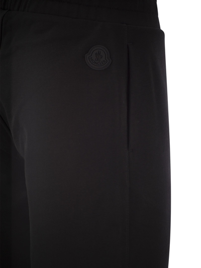 Shop Moncler Logo Embossed Sports Trousers