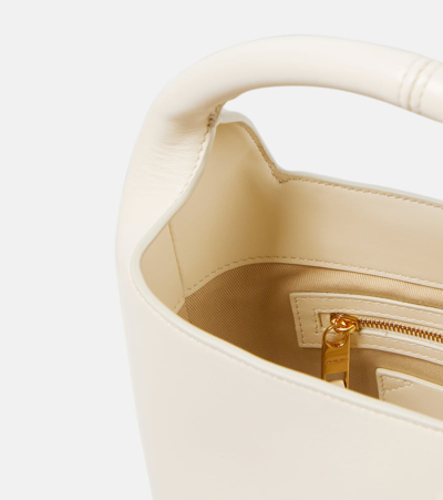 Shop Jacquemus Le Petit Tourni Mini Leather Bucket Bag In Light Ivory