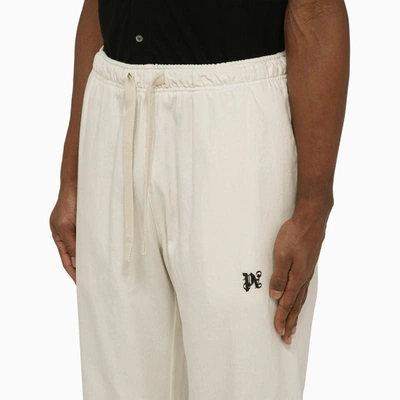 Shop Palm Angels Off-white Jogging Trousers With Monogram