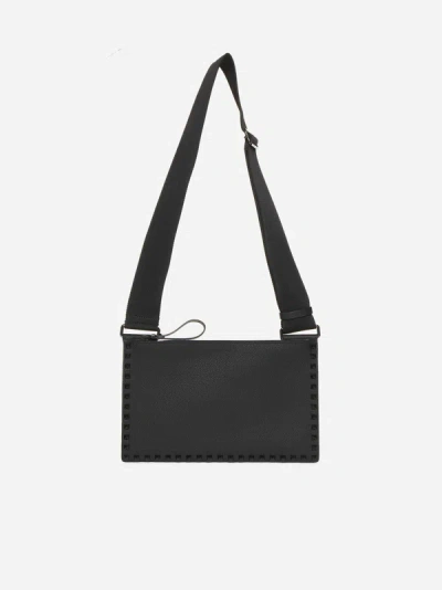 Shop Valentino Rockstud Flat Mini Leather Crossbody Bag In Black