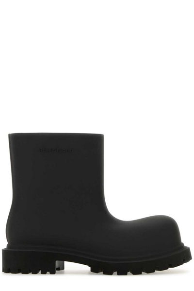 Shop Balenciaga Logo Embossed Ankle Boots In Black