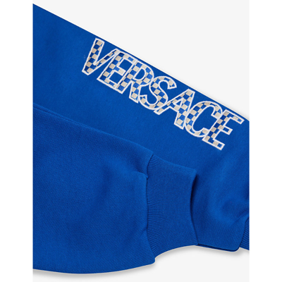 Shop Versace Logo Text-print Cotton-jersey Jogging Bottoms 9-36 Months In Bed Time+white