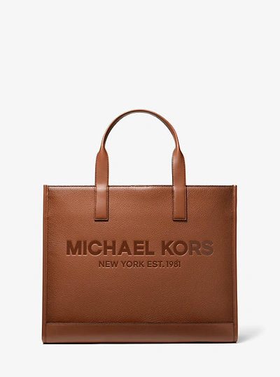 Shop Michael Kors Cooper Logo Embossed Pebbled Leather Tote Bag In Brown