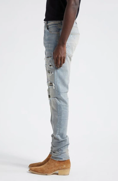 Shop Amiri Thrasher Ripped Camo Patches Skinny Jeans In Antique Indigo