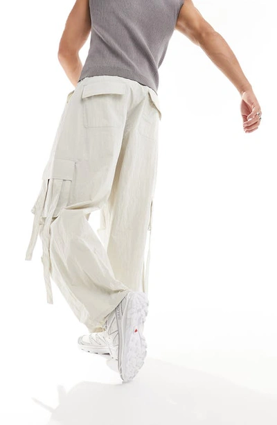 Shop Asos Design Crinkle Nylon Cargo Pants In Cream
