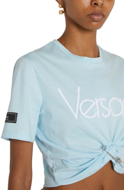 Shop Versace 1978 Re-edition Logo Safety Pin Crop Graphic T-shirt In Pale Blue/ Bianco