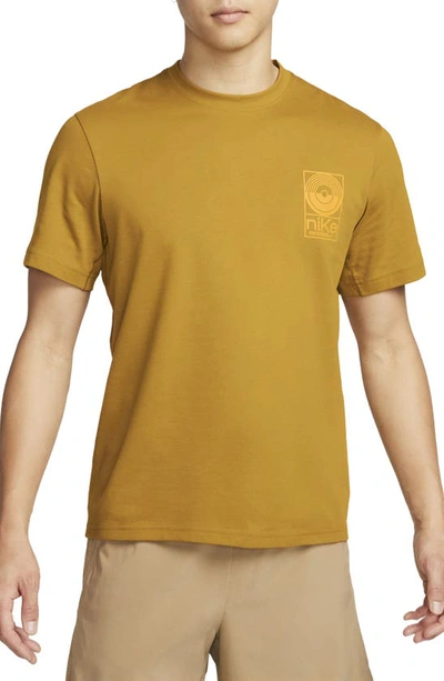 Shop Nike Dri-fit Studio '72 Graphic T-shirt In Bronzine/ Sundial