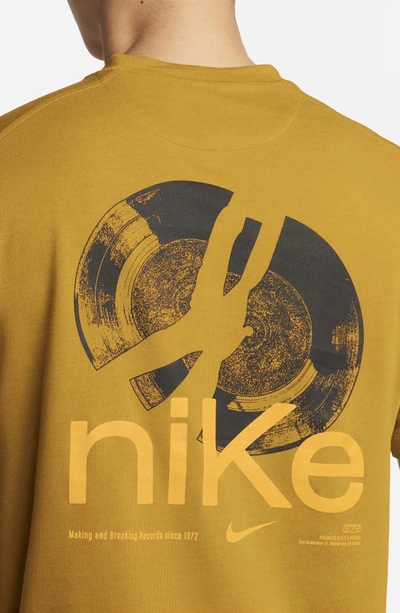 Shop Nike Dri-fit Studio '72 Graphic T-shirt In Bronzine/ Sundial