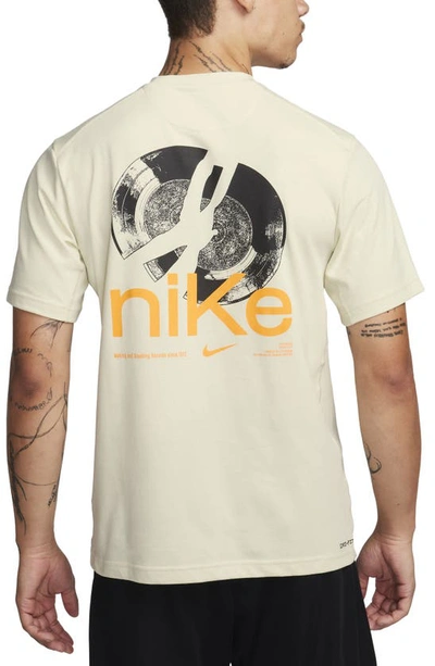 Shop Nike Dri-fit Studio '72 Graphic T-shirt In Sea Glass/ Sundial