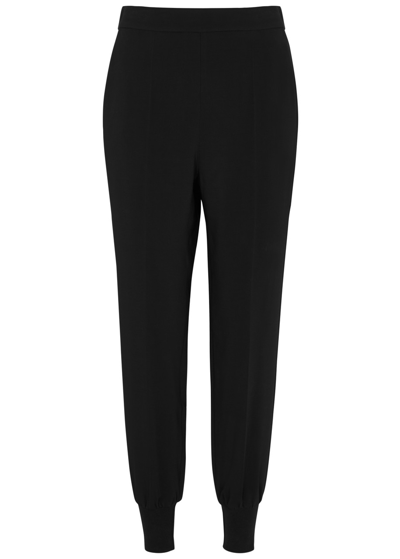 Shop Stella Mccartney Iconic Tapered Stretch-jersey Trousers In Black