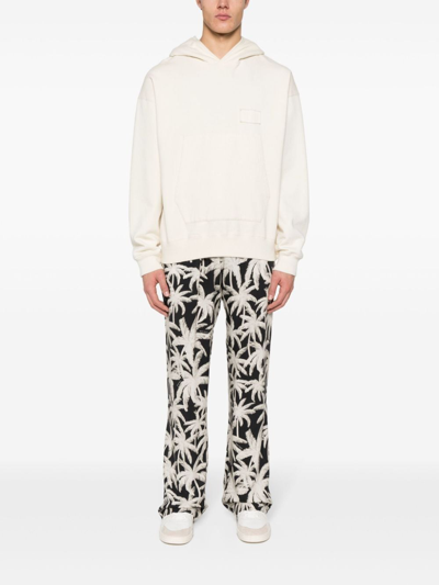 Shop Palm Angels Allover Logo Loose Fit Trousers In Black