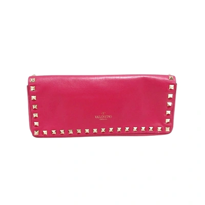 Shop Valentino Garavani Rockstud Pink Leather Clutch Bag ()