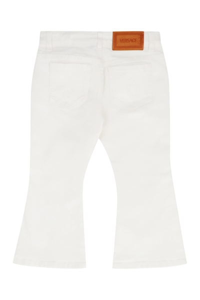 Shop Young Versace Cotton Flared Jeans In White
