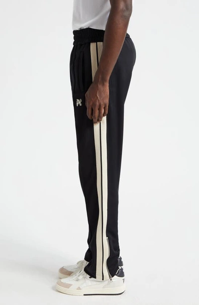 Shop Palm Angels Monogram Embroidered Track Pants In Black Off White
