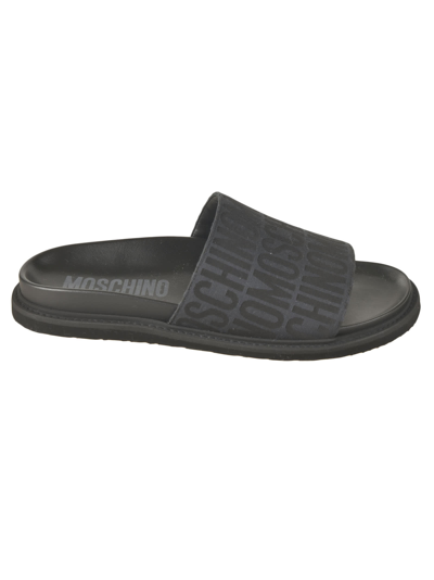 Shop Moschino All-over Logo Sliders In Black