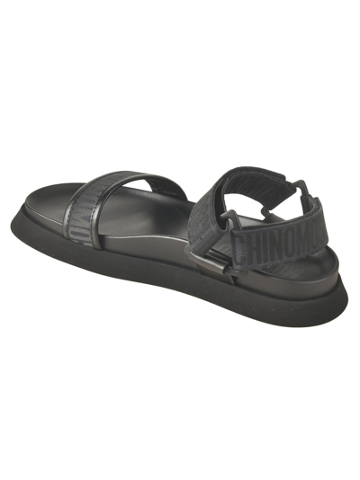 Shop Moschino Logo Strap Flat Sandals In Black