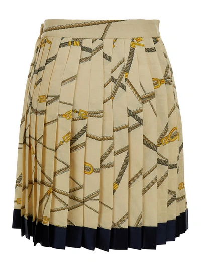 Shop Versace Pale Yellow Pleated Mini Skirt With All-over Logo Print In Silk Blend Woman In White