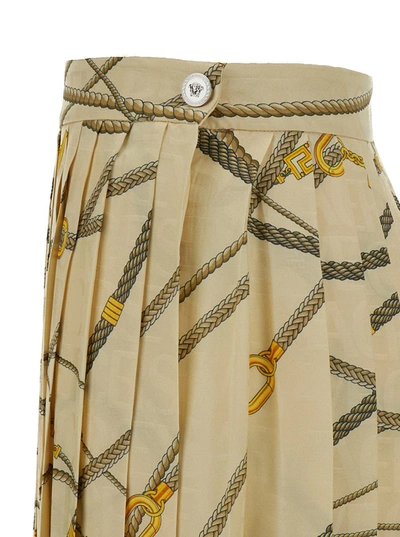 Shop Versace Pale Yellow Pleated Mini Skirt With All-over Logo Print In Silk Blend Woman In White