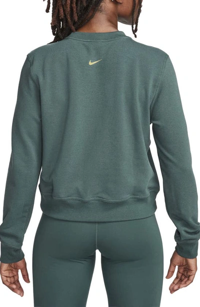 Shop Nike One Dri-fit Crewneck Graphic Sweatshirt In Deep Jungle/ Bronzine